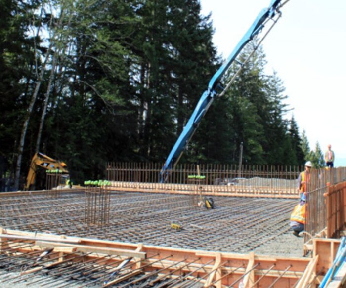 Concrete rebar and boom pump at Powell River water system upgrade site