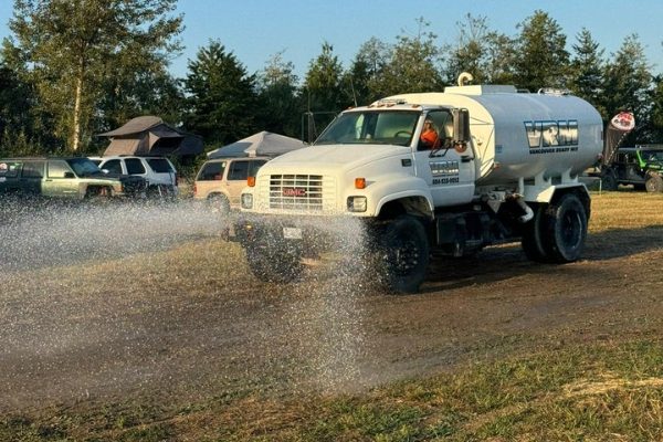 langley-bc-concrete- water truck VRM water truck spraying field in Langley, BC for dust control